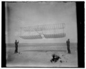  1901 glider being flown as a kite, Wilbur at left side, Orville at right; Kitty Hawk, North Carolina 

