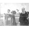 Count Jacques de Lesseps (right), two men and a woman on a field.