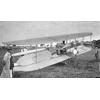 Frank Coffyn standing behind Wright transitional aircraft packed for transportation.