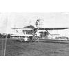 Postcard of Wilbur Wright, Frank Coffyn, and Duval La Chapelle inspecting Wright transitional aircraft.