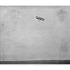 Frank Coffyn flying a Model B with a passenger.