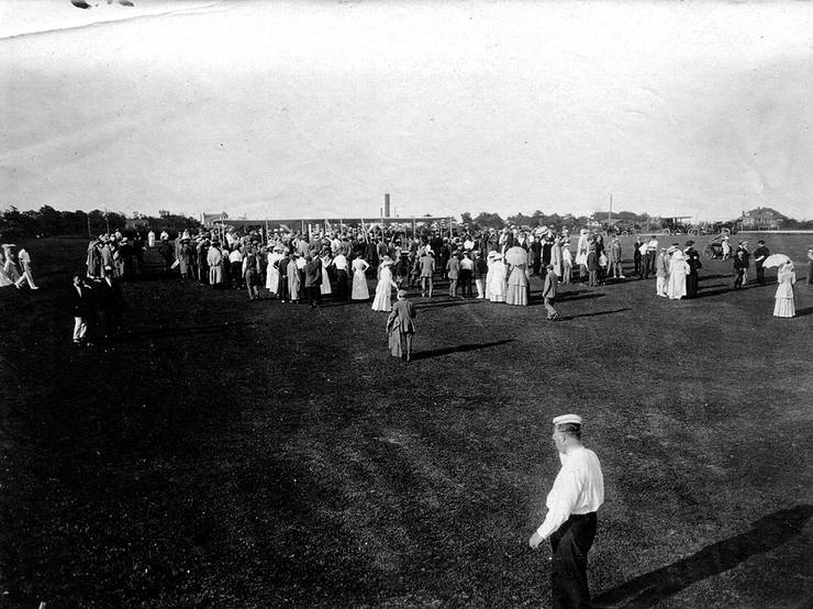 Wright Model B surrounded by a crowd at an exhibition.