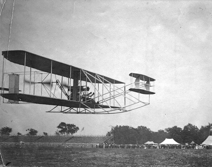 Unidentified Wright pilot (possibly Brookins) in a Wright transitional in front of grandstands
