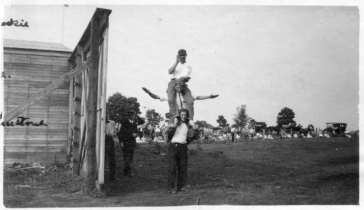 Walter Brookins (top), Frank Coffyn (middle), and Ralph Johnstone (bottom) on each others' shoulders.