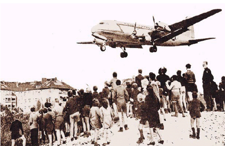 Children watching plane arrive