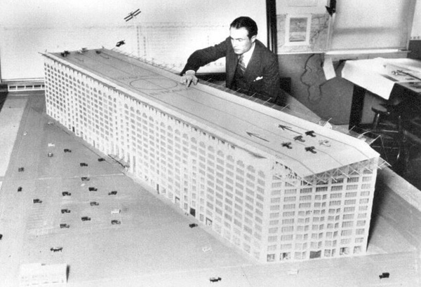 Chief engineer of Los Angles, O.R. Angelillo, demonstrates a model skyscraper air terminal