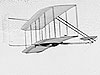 Wilbur flying the 1902 glider,Dan Tate followingImage credit: Library of Congress